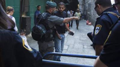 Un policía fronterizo israelí ordena a un palestino que se aleje de la calle cortada en el barrio musulmán de Jerusalén.