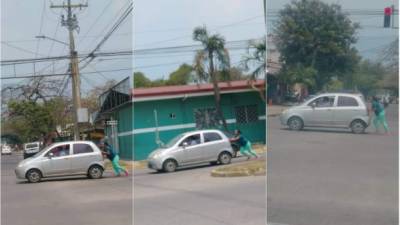 La secuencia de imágenes de la mujer empujando un vehículo en la ciudad de San Pedro Sula, zona norte de Honduras.