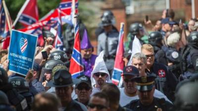 (FILES) This file photo taken on July 08, 2017 shows members of the Ku Klux Klan and others arriving for a rally, calling for the protection of Southern Confederate monuments, in Charlottesville, Virginia on July 8, 2017.A sizeable contingent of members of the extreme right and white nationalists are expected to descend on a small US university town on August 12, 2017 -- and a fierce opposition front is uniting against it.Thousands of white nationalists, including supporters of the Ku Klux Klan white supremacist group, and anti-fascist activists are expected to clash in Charlottesville, Virginia, a sleepy town planning to remove a statue of General Robert E. Lee, who led Confederate forces in the US Civil War. / AFP PHOTO / ANDREW CABALLERO-REYNOLDS