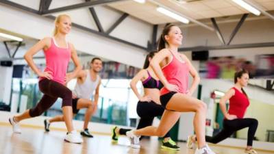 fitness, sport, training, gym and lifestyle concept - group of smiling people exercising in the gym