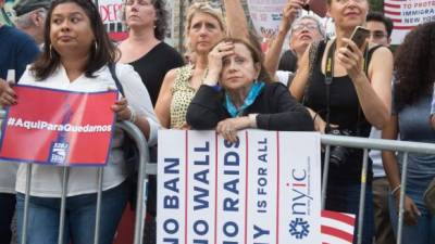 Protesters hold signs at a rally to defend DACA on September 5, 2017 in New York. US President Donald Trump ended an amnesty protecting 800,000 people brought to the US illegally as minors from deportation. 'I am here today to announce that the program known as DACA that was effectuated under the Obama Administration is being rescinded,' US Attorney General Jeff Sessions announced. / AFP PHOTO / Bryan R. Smith