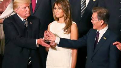 US President Donald Trump and US First Lady Melania Trump and wife of South Korea's President Kim Jung-sook attend a concert at the Elbphilharmonie concert hall during the G20 Summit in Hamburg, Germany, on July 7, 2017.Leaders of the world's top economies will gather from July 7 to 8, 2017 in Germany for likely the stormiest G20 summit in years, with disagreements ranging from wars to climate change and global trade. / AFP PHOTO / POOL / Christian Charisius