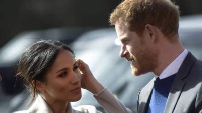 (FILES) In this file photo taken on March 23, 2018 Britain's Prince Harry and US actress and fiancee of Britain's Prince Harry Meghan Markle arrive at the Eikon Centre in Lisburn, Northern Ireland, to attend an event to mark the second year of youth-led peace-building initiative Amazing the Space. It was love at first sight for Prince Harry and Meghan Markle, who both quickly sensed their brief encounter on a blind date could blossom into something much, much bigger. / AFP PHOTO / Mark MARLOW