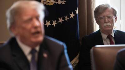 (FILES) In this file photo taken on April 9, 2018 New National Security Adviser John Bolton(R) listens to US President Donald Trump speak during a cabinet meeting at the White House in Washington, DC. - President Donald Trump on January 27, 2020 denied that he told his former national security advisor John Bolton that military aid to Ukraine was tied to Kiev investigating his political rivals. Trump's tweets came after The New York Times reported Sunday that Bolton alleges as much in a draft of his upcoming book.'I NEVER told John Bolton that the aid to Ukraine was tied to investigations into Democrats, including the Bidens. In fact, he never complained about this at the time of his very public termination,' Trump tweeted in the early hours of January 27,2020. (Photo by NICHOLAS KAMM / AFP)