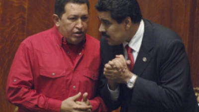 FILE - In this Dec. 18, 2007 file photo Venezuela's President Hugo Chavez, left, talks to then Foreign Minister Nicolas Maduro at the University of Uruguay in Montevideo, Uruguay. Chavez hasn't been seen or heard from since his Dec. 11 cancer surgery, and speculation has grown that his illness could be reaching its final stages. Maduro, who is now vice president and Chavez's chosen successor, is reported to have delayed plans to return home Wednesday, Jan. 2, 2013, after at least two bedside visits with Chavez. The government has provided few details but describes the ailing president's condition, after complications due to a respiratory infection, as 'delicate.' (AP Photo/Matilde Campodonico, File)