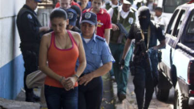 Mexican Raquel Alatorre Correa, left, and others detainees, all facing organized crime and money laundering charges, are escorted to a court hearing, in Managua, Nicaragua, Friday, Nov 9, 2012. The group was traveling on Aug. 24 inside a Televisa TV truck with 'press badges,' highdefinition video cameras, microphones and a satellite dish and according to authorities, hidden beneath the sound boards and screens in three of the vans, officers found black gym bags stuffed with $9.2 million in cash for alleged use in drug trafficking. (AP Photo/Esteban Felix)