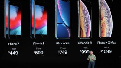 A woman tries out a new Apple 11 Pro during an Apple product launch event at Apple's headquarters in Cupertino, California on September 10, 2019. - Apple unveiled its iPhone 11 models Tuesday, touting upgraded, ultra-wide cameras as it updated its popular smartphone lineup and cut its entry price to $699. (Photo by Josh Edelson / AFP)