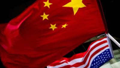 In this Nov. 7, 2012 photo, U.S. and Chinese national flags are hung outside a hotel during the U.S. Presidential election event, organized by the U.S. embassy in Beijing. As public evidence mounts that the Chinese military is responsible for stealing massive amounts of U.S. government data and corporate trade secrets, the Obama administration is eyeing fines and other trade actions it may take against Beijing or any other country guilty of cyberespionage. The Chinese government, meanwhile, has denied involvement in the cyber-attacks tracked by Mandiant. Instead, the Foreign Ministry said that China, too, is a victim of hacking, some of it traced to the U.S. Foreign Ministry spokesman Hong Lei cited a report by an agency under the Ministry of Information Technology and Industry that said in 2012 alone that foreign hackers used viruses and other malicious software to seize control of 1,400 computers in China and 38,000 websites. (AP Photo/Andy Wong)