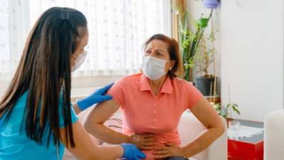 Abdominal pain patient woman having medical exam with doctor on illness from stomach cancer, irritable bowel syndrome, pelvic discomfort, Indigestion, Diarrhea, GERD (gastro-esophageal reflux disease)