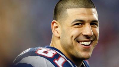 (FILES) This file photo taken on December 09, 2012 shows Aaron Hernandez #81 of the New England Patriots smiling from the sidelines in the fourth quarter during a game against the Houston Texans at Gillette Stadium in Foxboro, Massachusetts. Former American football star Aaron Hernandez on April 19, 2017 was found dead in prison where he was serving a life sentence for murder, after hanging himself with a bedsheet, prison officials said. Hernandez, 27, was discovered hanging in his cell by corrections officers in Shirley, Massachusetts at approximately 3:05 am (0705 GMT) Wednesday, Christopher Fallon with the Massachusetts Department of Correction said.'Mr. Hernandez hanged himself utilizing a bedsheet that he attached to his cell window,' Fallon's statement said. / AFP PHOTO / GETTY IMAGES NORTH AMERICA / Jim Rogash