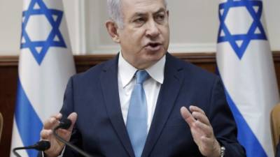 Benjamin Netanyahu se congratuló por la puesta en marcha de este proyecto destinado a 'hacer partir a los migrantes llegados ilegalmente'./ AFP PHOTO / POOL / Tsafrir ABAYOV