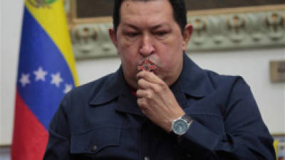 ALTERNATIVE CROP OF XFLL103,- In this photo released by Miraflores Press Office, Venezuela's President Hugo Chavez kisses a crucifix during a televised speech form his office at Miraflores Presidential palace in Caracas, Venezuela, Saturday, Dec. 8, 2012. Chavez announced Saturday night that his cancer has returned and that he will undergo another surgery in Cuba. Chavez, who won re-election on Oct. 7, also said for the first time that if his health were to worsen, his successor would be Vice President Nicolas Maduro.(AP Photo/Miraflores Press Office, Marcelo Garcia)