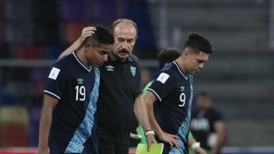 El seleccionador de Guatemala, Rafael Loredo, consuela a sus jugadores Anderson Villagran y Jefry Bantes tras la derrota ante Uzbekistán.