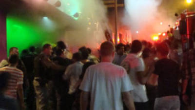 A crowd stands outside the Kiss nightclub during a fire inside the club in Santa Maria city, Rio Grande do Sul state, Brazil, Sunday, Jan. 27, 2013. A blaze raced through the crowded nightclub in southern Brazil early Sunday, killing 245 people as the air filled with deadly smoke and panicked party-goers stampeded toward the exits, police and witnesses said. It appeared to be the world's deadliest nightclub fire in more than a decade.(AP Photo/Roger Shlossmacker)