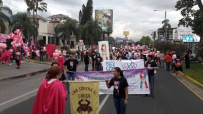 Cerca de 200 personas marchan contra el cáncer de mama.
