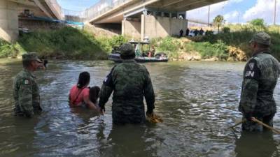 Militares mexicanos intentan impedir que un grupo de migrantes cruce hacia EEUU./