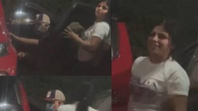 Imágenes sustraídas del video cuando la pareja abría la puerta del vehículo estacionado para sustraer las pertenencias.