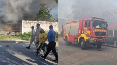 Bomberos atienden la emergencia del incendio en el barrio Barandillas de San Pedro Sula.