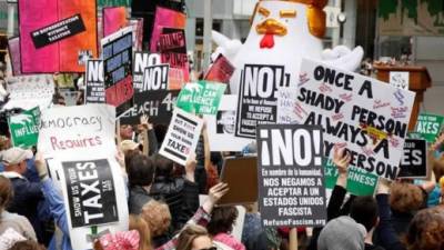 Los manifestantes sostienen letreros durante una Marcha de Protesta del Día del Impuesto en las afueras de Bryant Park en Nueva York, Nueva York, Estados Unidos, el 15 de abril de 2017. La protesta marchará hasta la Torre Trump en la Quinta Avenida. EFE