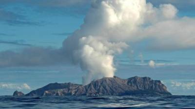 This handout photo taken on July 23, 2019 and released to AFP courtesy of Chris Firkin on December 9, 2019 shows the volcano on New Zealand's White Island spewing steam and ash. - About 100 tourists were 'on or around' New Zealand's White Island volcano when it erupted on December 9, 2019, and an unknown number are unaccounted for, the country's prime minister said. (Photo by Chris Firkin / Courtesy of Chris Firkin / AFP) / -----EDITORS NOTE --- RESTRICTED TO EDITORIAL USE - MANDATORY CREDIT 'AFP PHOTO / COURTESY OF CHRIS FIRKIN' - NO MARKETING - NO ADVERTISING CAMPAIGNS - DISTRIBUTED AS A SERVICE TO CLIENTS - NO ARCHIVES