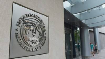 (FILES) This file photo taken on June 30, 2015 shows the IMF logo seen outside the headquarters of the International Monetary Fund in Washington, DC. The lack of details on President Donald Trump's plans to reform the US economy prompted the International Monetary Fund on June 27, 2017 to cut its growth forecast for this year and next.The IMF in January raised the estimates on the expectation of fiscal stimulus from the Trump administration, but have reverted back to the previous calculations -- which project the economy to expand by 2.1 percent in 2017 and 2018, down from 2.3 percent and 2.5 percent, respectively. / AFP PHOTO / BRENDAN SMIALOWSKI