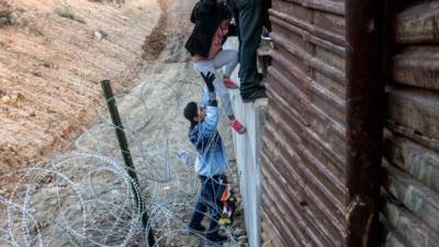 Los migrantes que lograron saltar el muro se entregaron a las autoridades estadounidenses para solicitar asilo./