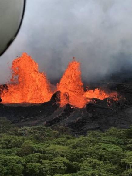 This image released by the US Geological Survey on May 22, 2018 shows lava spattering as a helicopter flies over K?lauea Volcano's Lower East Rift Zone shows fountaining at Fissure 22 taken on May 21, 2018. <br/>Authorities in Hawaii have warned of dangerous 'laze' fumes as molten lava from the erupting Kilauea volcano reached the Pacific Ocean. Two lava flows 'reached the ocean along the southeast Puna coast overnight,' on Hawaii's Big Island, the US Geological Survey, which monitors volcanoes and earthquakes worldwide, said in a statement May 20, 2018.<br/><br/> / AFP PHOTO / US Geological Survey / HO / RESTRICTED TO EDITORIAL USE - MANDATORY CREDIT 'AFP PHOTO / US Geological Survey/HO' - NO MARKETING NO ADVERTISING CAMPAIGNS - DISTRIBUTED AS A SERVICE TO CLIENTS<br/><br/>