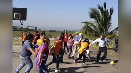 Tim Kaine -camisa celeste y pantalón negro- jugando al fútbol en febrero de 2015 en la zona de Chamelecón.