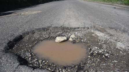 Los grandes hoyos están por todos lados de la carretera CA-13, haciendo que el recorrido dure más horas.