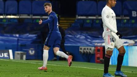 Chelsea's German striker Timo Werner (L) celebrates scoring the opening goal during the UEFA Champions League second leg semi-final football match between Chelsea and Real Madrid at Stamford Bridge in London on May 5, 2021. (Photo by Glyn KIRK / AFP)