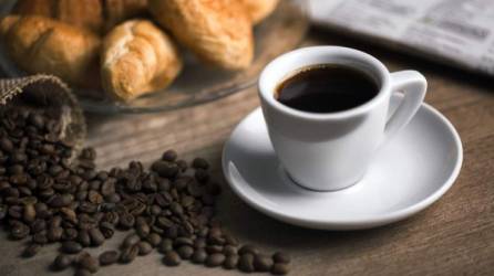 Cup of coffee with beans and cookies