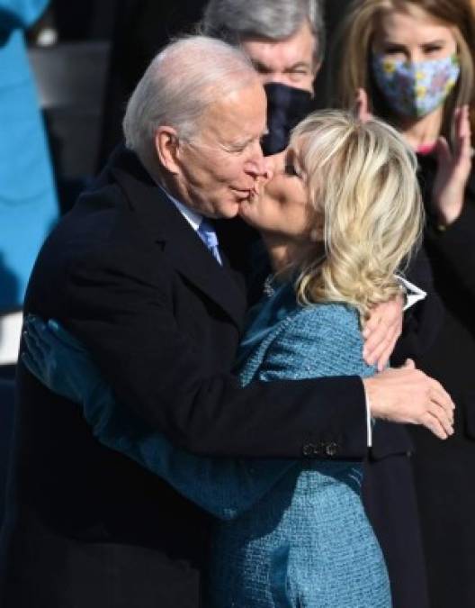 Joe Biden embraces his wife Jill after being sworn in as the 46th US President by Supreme Court Chief Justice John Roberts on January 20, 2021, at the US Capitol in Washington, DC. (Photo by Brendan SMIALOWSKI / AFP)