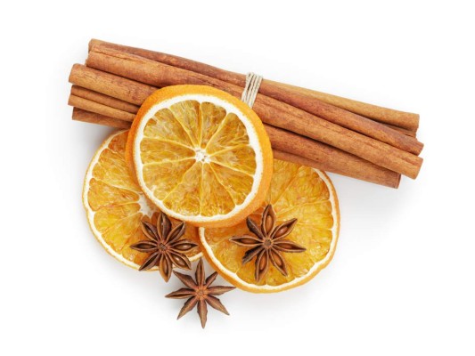 dried oranges with cinnamon and anise, isolated on white background