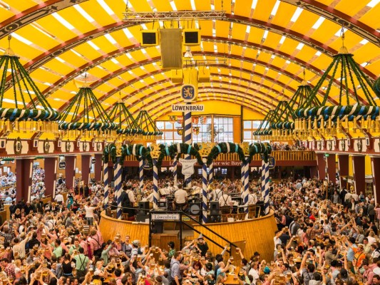 Munich, Germany - October 2, 2014: People drinking in the Loewenbrau Beer Tent on the Theresienwiese Oktoberfest fair grounds