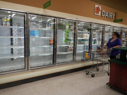 As remants of Hurricane Irma disapates over the southeastern US September 13, 2017, a market 150 miles to the east of the storm's path near Kennedy Space Center, Florida, is still trying to keep its shelves stocked with lunch meat, hot dogs and sausages. Irma traveled up the west coast of Florida, while losing some strength, it remained a very large storm affecting the whole state. / AFP PHOTO / BRUCE WEAVER