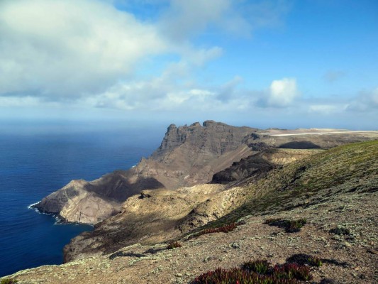 (FILES) This file photo taken on March 15, 2015 shows the edge of the runway of the future airport of the island of Saint Helena currently under construction in Jamestown. The first commercial air link to St Helena will touch down on October 14, 2017, on the remote island's windswept new runway. Until then, St Helena was one of the world's most isolated and inaccessible locations. It was only routinely reachable by sea, requiring a five-day-long voyage from Cape Town aboard a Royal Mail vessel that typically chugs along at a speed of just 15 knots (30 kilometres an hour). / AFP PHOTO / JEAN LIOU