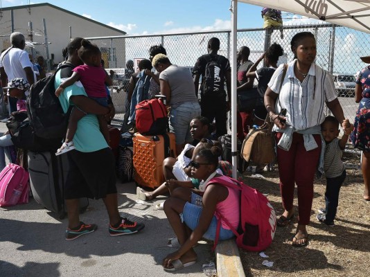 People wait to have their documents checked by airport workers so they can fly to the United States at the airport at Freeport on Grand Bahama island on September 10, 2019. - Some 2,500 people are unaccounted for in the Bahamas following Hurricane Dorian, the Bahamian National Emergency Management Agency (NEMA) said September 11, 2019. At least 50 people died in the hurricane, which slammed into the northern Bahamas as a Category 5 storm, and officials have said they expect the number to rise significantly. (Photo by Leila MACOR / AFP)