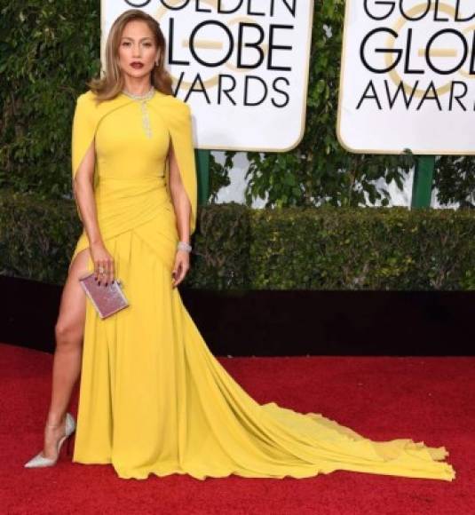 2016- Giambatista Valli<br/><br/>Demostrando que puede deslumbrar sin mostrar tanto la cantante apareció en los Globos de Oro luciendo divina en un vestido de amarillo con capa.