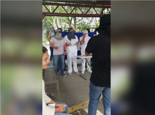 Estudiantes de la Universidad Nacional Autónoma de Honduras en el Valle de Sula leyendo un comunicado este viernes sobre la toma de las instalaciones.