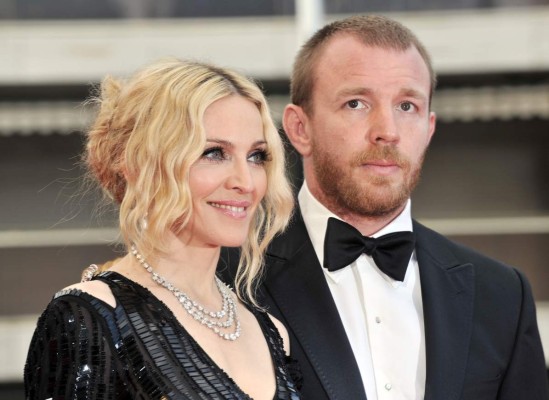 US singer Madonna (L) and her husband British director Guy Ritchie pose as they arrive to attend the screening of Nathan Rissman's film 'I Am Beacuse We Are' at the 61st Cannes International Film Festival on May 21, 2008 in Cannes, southern France. The May 14-25 festival winds up with the awards ceremony for the prestigious Palme d'Or, to be determined by a jury headed by Hollywood 'bad boy' Sean Penn. AFP PHOTO / ANNE-CHRISTINE POUJOULAT (Photo credit should read ANNE-CHRISTINE POUJOULAT/AFP/GettyImages)