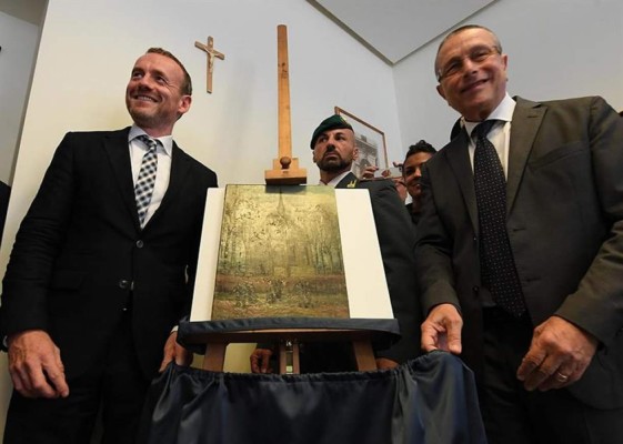 El director del museo Van Gogh, Axel Ruger permanece junto a una de las pinturas del artista Vincent Van Gogh titulada 'Salida de la iglesia de Nuenen' durante la rueda de prensa de hoy con los investigadores italianos en Nápoles, Italia. EFE