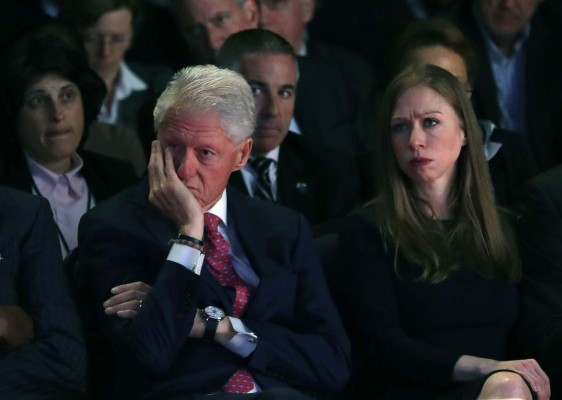 Bill and Chelsea Clinton are seen during the first presidential debate at Hofstra University in Hempstead, New York on September 26, 2016.Hillary Clinton and Donald Trump face off in one of the most consequential presidential debates in modern US history with up to 100 million viewers set to tune in. / AFP PHOTO / POOL / joe raedle
