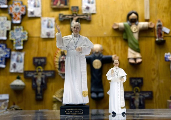 View of statuettes of Pope Francis for sale in an store near El Zocalo square in Mexico City on February 10, 2016. Pope Francis will visit four Mexican states from next February 12 to 17. AFP PHOTO / Yuri CORTEZ