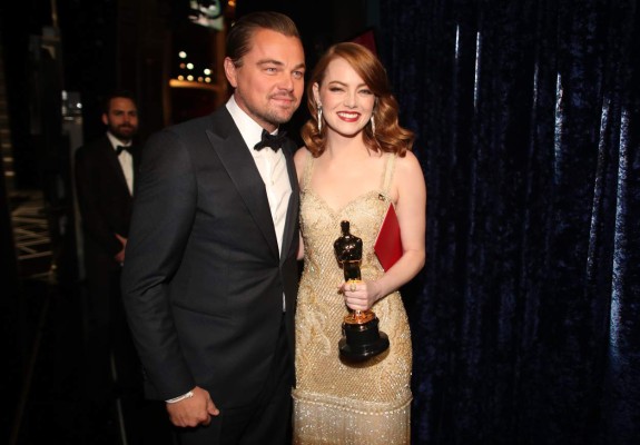 HOLLYWOOD, CA - FEBRUARY 26: Actor Leonardo DiCaprio (L) and actress Emma Stone, winner of Best Actress for 'La La Land' pose backstage during the 89th Annual Academy Awards at Hollywood & Highland Center on February 26, 2017 in Hollywood, California. Christopher Polk/Getty Images/AFP