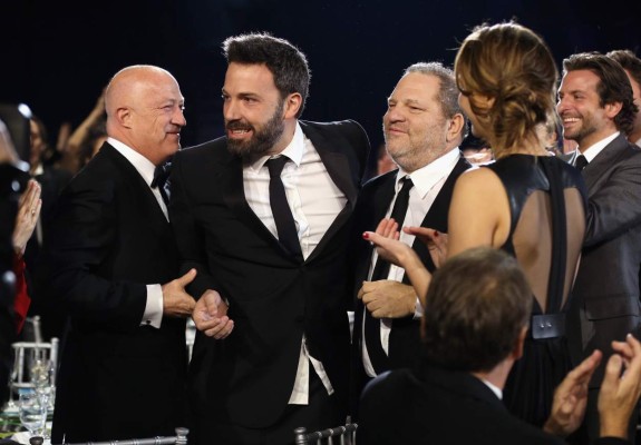 (FILES) This file photo taken on January 10, 2013 shows (L-R) Co-Chairman of Creative Artists Agency Bryan Lourd, director Ben Affleck and co-chairmen of The Weinstein Company Harvey Weinstein attending the 18th Annual Critics' Choice Movie Awards held at Barker Hangar in Santa Monica, California. New York police said on October 12, 2017 they have reopened a investigation into allegations of a 2004 sexual assault by disgraced movie mogul Harvey Weinstein. An avalanche of claims of sexual harassment, assault and rape by the Hollywood heavyweight have surfaced since the publication last week of an explosive New York Times report alleging a history of abusive behavior dating back decades. / AFP PHOTO / GETTY IMAGES NORTH AMERICA / Christopher Polk