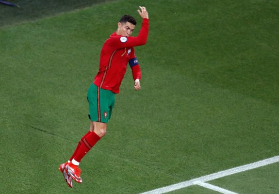 Portugal's forward Cristiano Ronaldo celebrates scoring the opening goal from the penalty spot during the UEFA EURO 2020 Group F football match between Portugal and France at Puskas Arena in Budapest on June 23, 2021. (Photo by Laszlo Balogh / POOL / AFP)