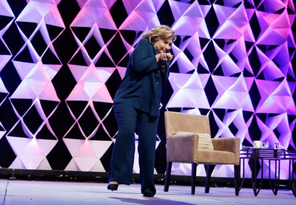 Una mujer lanza un zapato a Hillary Clinton durante un discurso