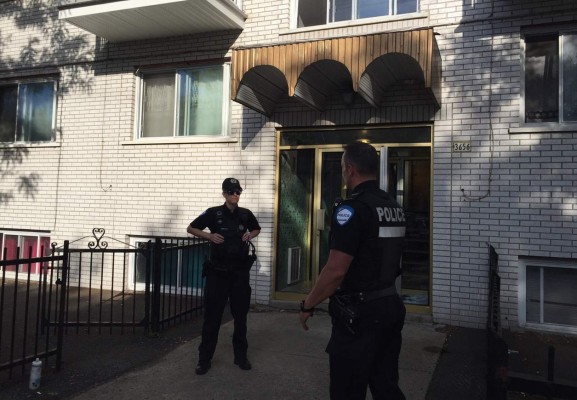 Montreal Police guard the front of the four storey building in Montreal on June 21, 2017, where Amor Ftouhi, who is suspected of stabbing a Michigan airport police officer, lived before traveling to the US earlier this month.The FBI said it is investigating as an 'act of terrorism' a knife attack the officer on Wednesday at Bishop International Airport in Flint, Michigan. Ftouhi, who is in custody and cooperating with investigators, is a Canadian resident in his 50s , FBI special agent David Gelios told a news conference. / AFP PHOTO / Julien BESSET