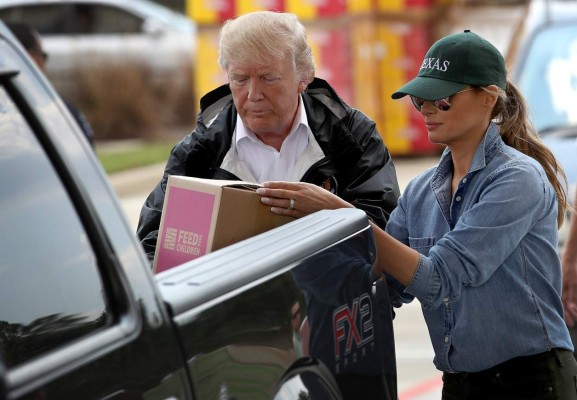 PEARLAND, TX - SEPTEMBER 02: U.S. President Donald Trump and first lady Melania Trump load emergency supplies into the back of a pickup truck for residents impacted by Hurricane Harvey while visiting the First Church of Pearland September 2, 2017 in Pearland, Texas. Pearland, just south of Houston, was heavily damaged by the floodwaters created by the hurricane. Win McNamee/Getty Images/AFP== FOR NEWSPAPERS, INTERNET, TELCOS & TELEVISION USE ONLY ==