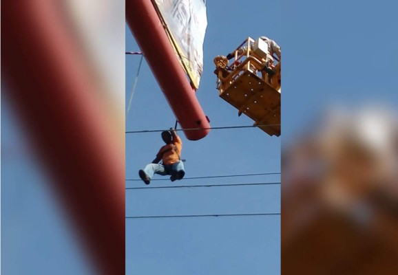 Bomberos rescatan a hombre que estaba a punto de caer en cables de alta tensión